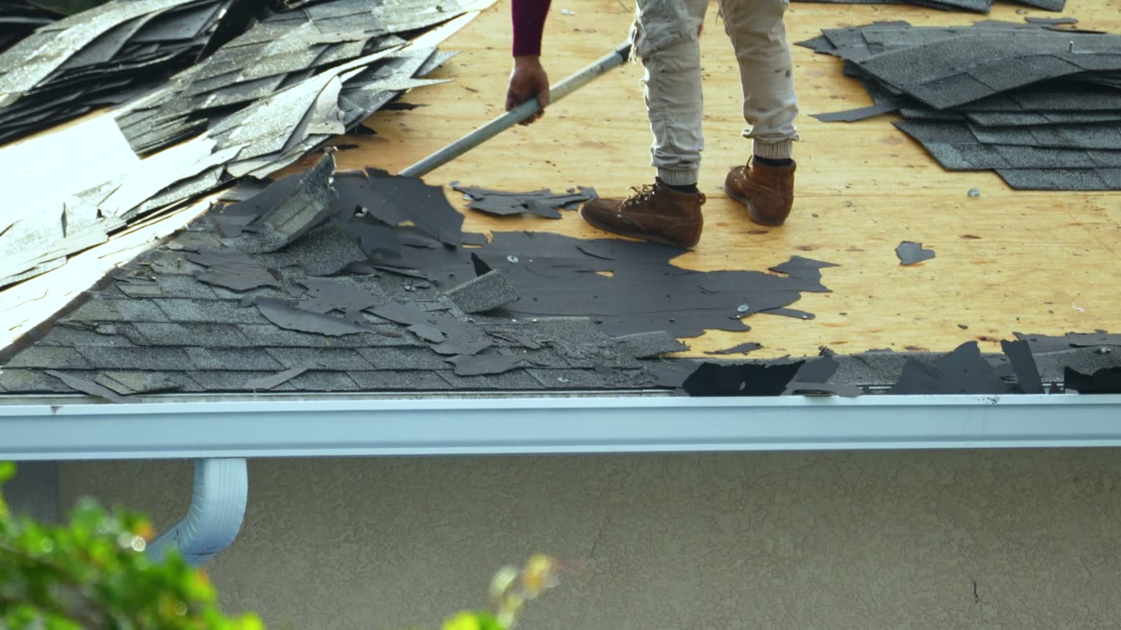 construction-worker-removing-old-shingles-from-roo.mp4