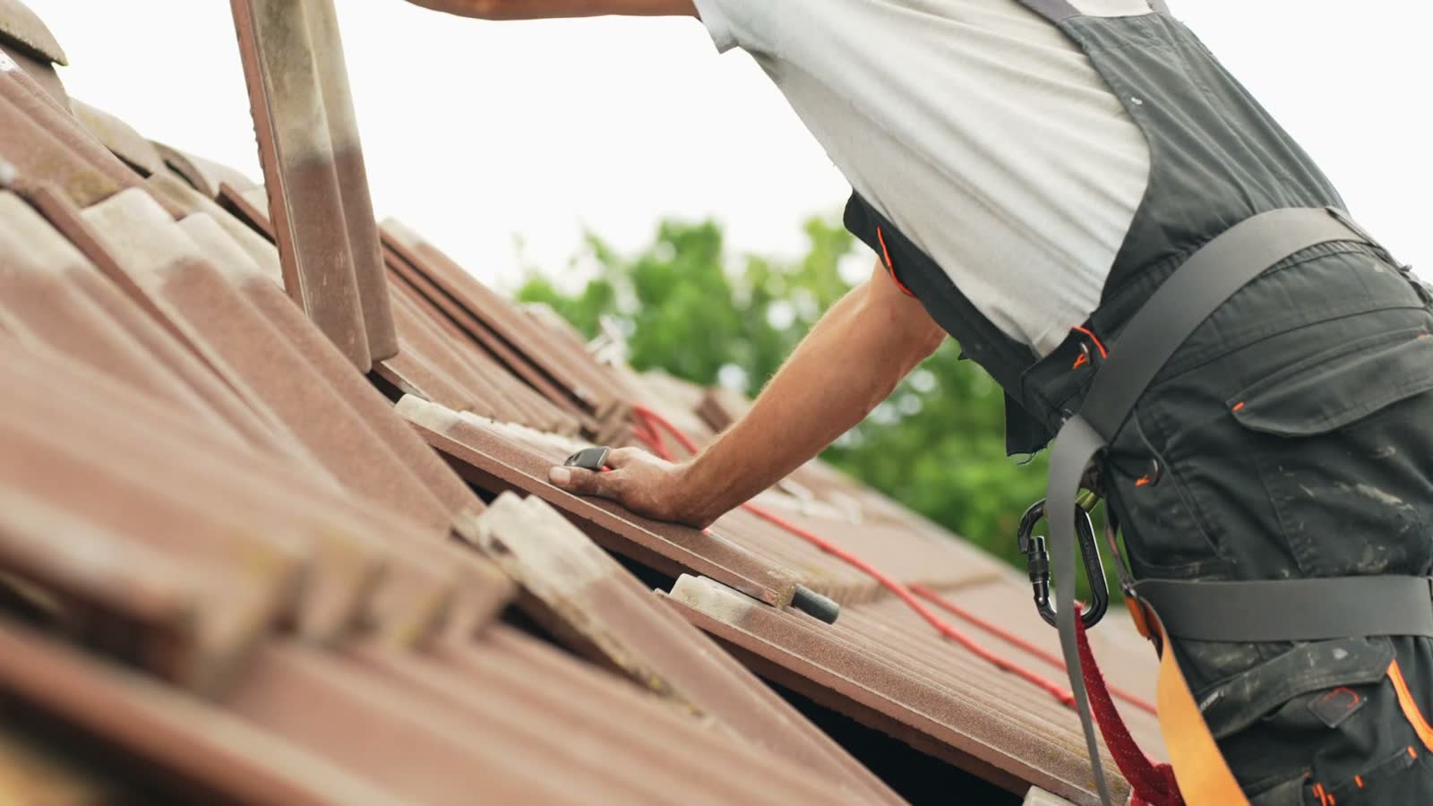 man-repairing-roof-tiles-in-close-up.mp4