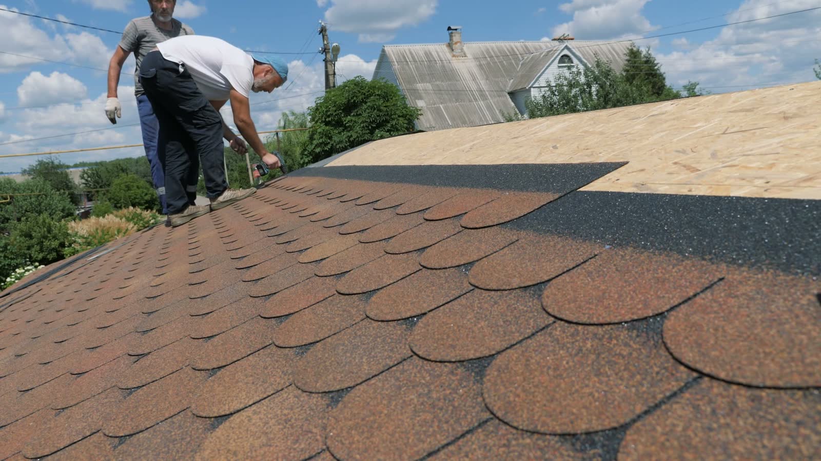 Roof mid-repair with a new shingle section against the old field, a visible mismatch