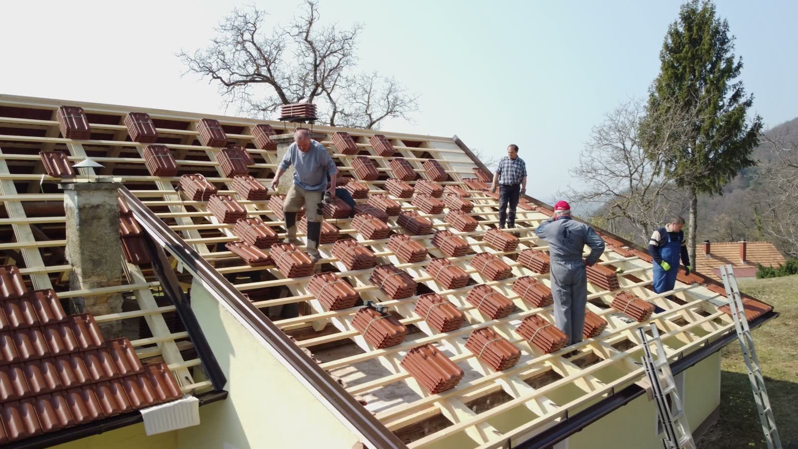men-installing-red-roof-tiles-on-house.mp4