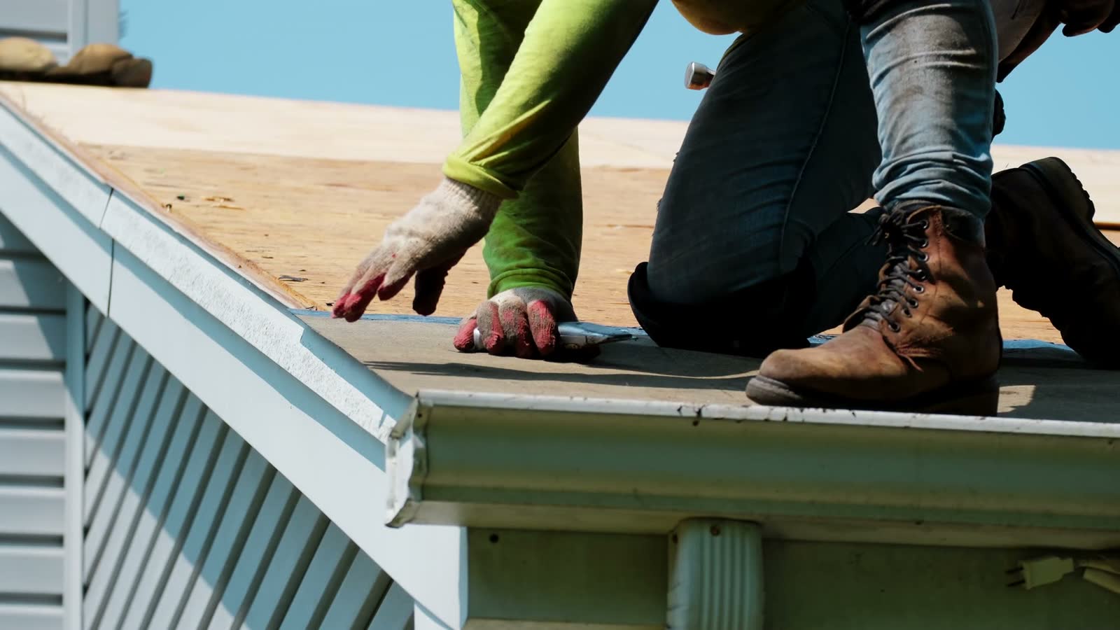 roofer-cutting-roofing-felt-on-suburban-house.mp4