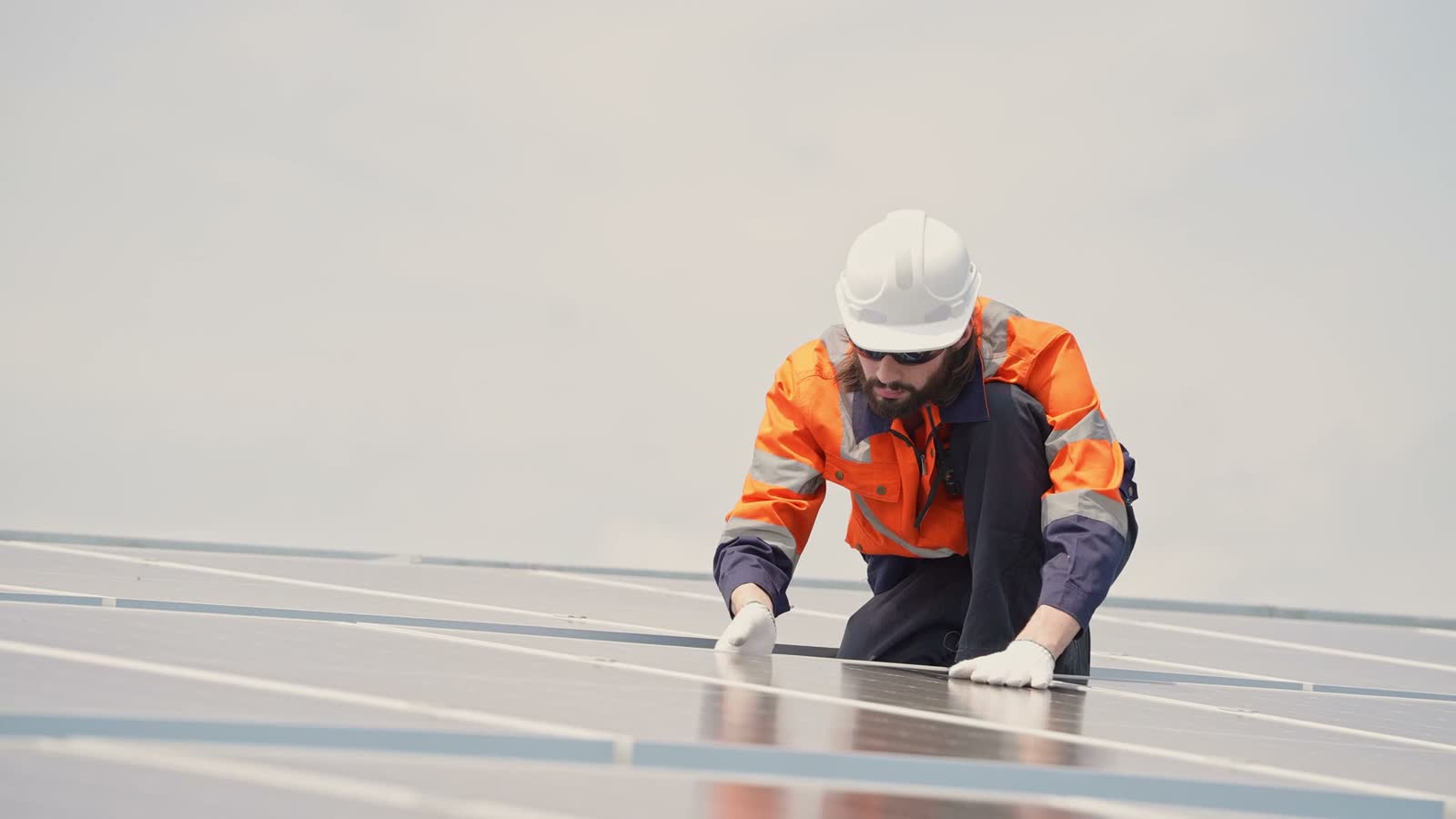 technician-inspecting-solar-panels-on-rooftop.mp4