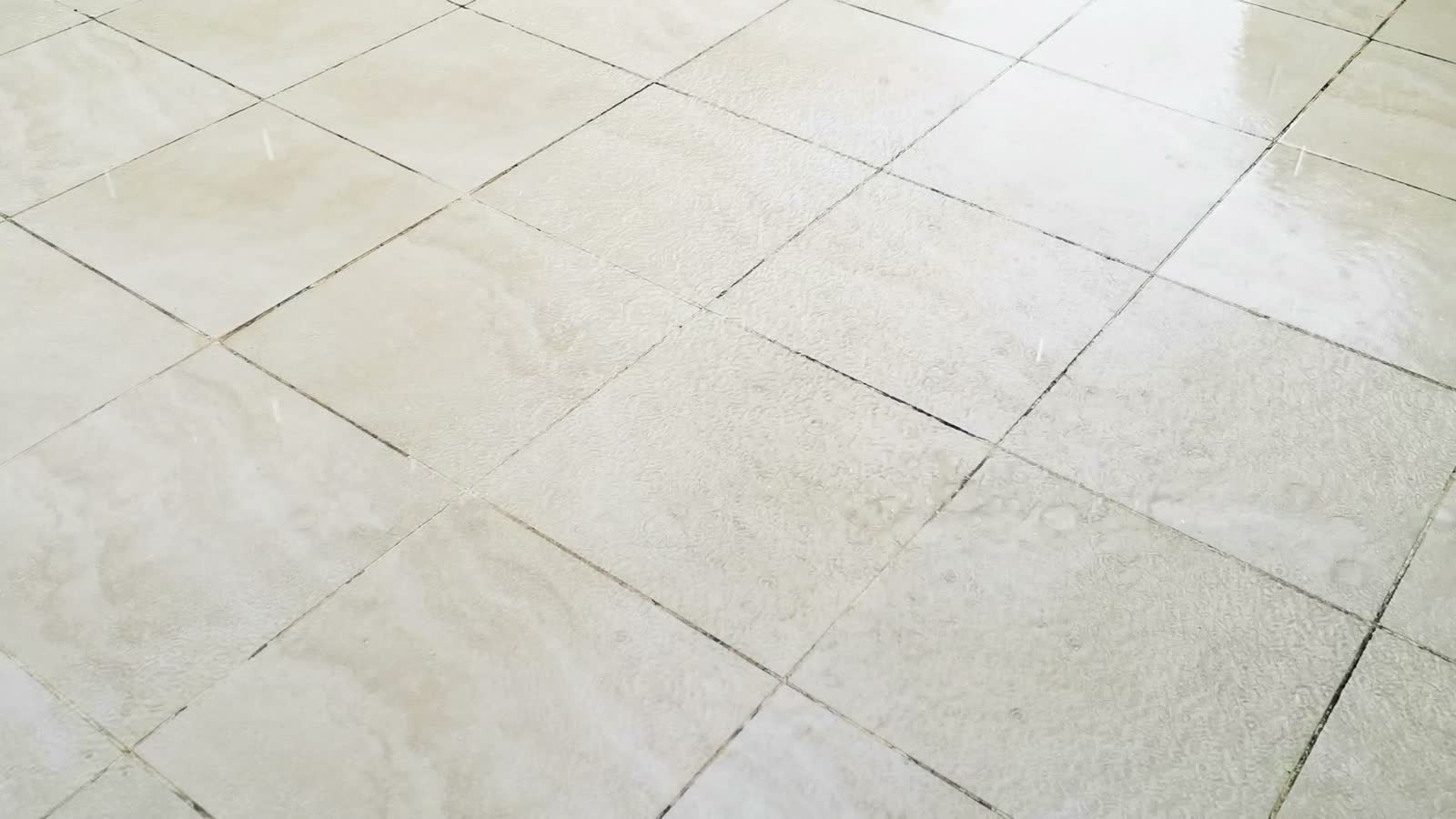 water-droplets-falling-on-light-tiled-floor.mp4
