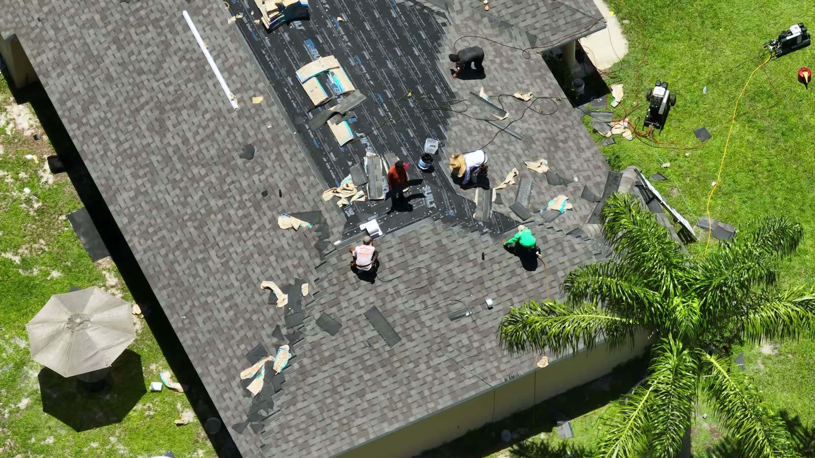 workers-laying-asphalt-shingles-on-new-house-rooft.mp4