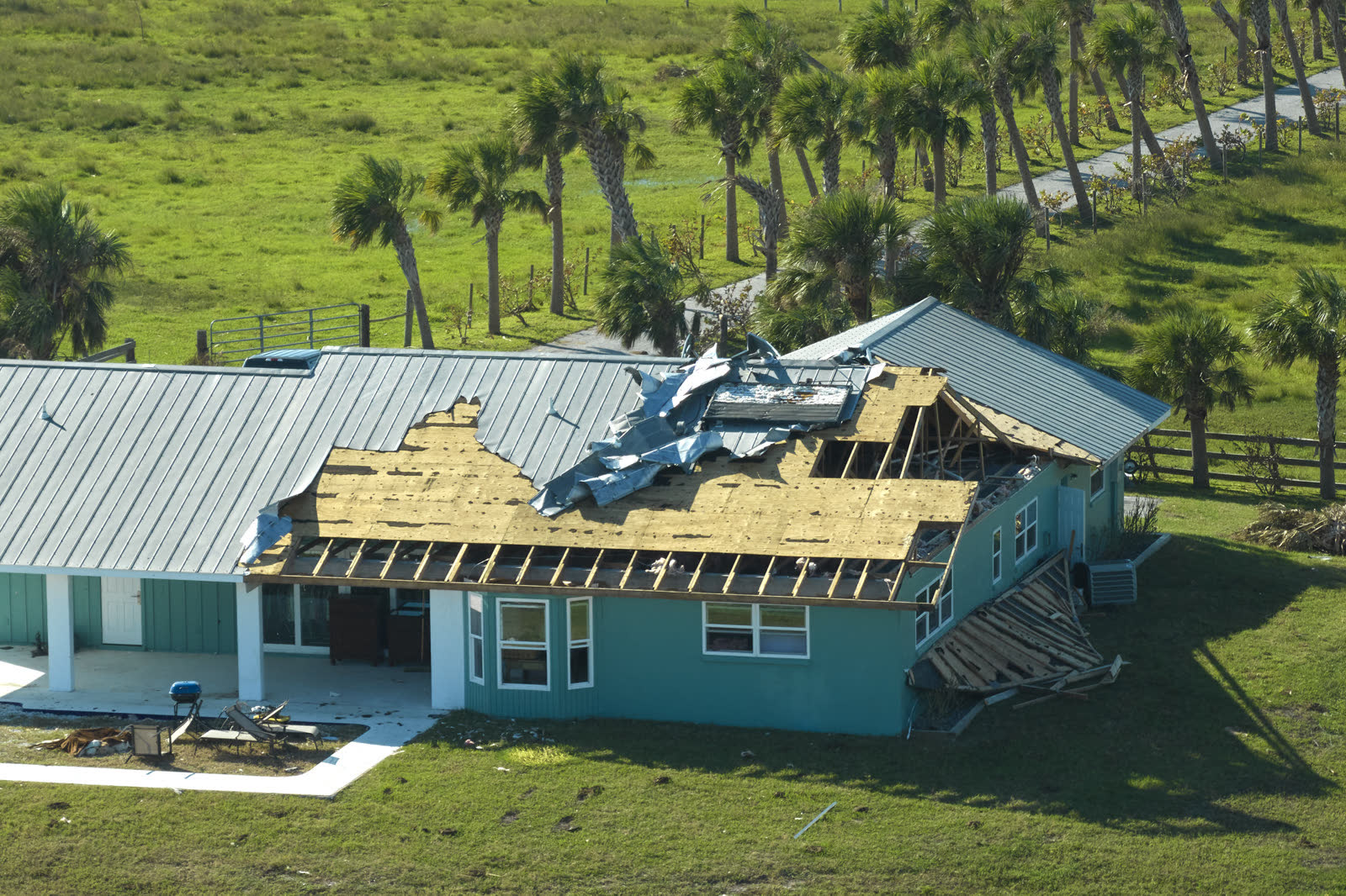 A house roof stripped of shingles by hurricane-force wind, the damage behind a denied Tampa, FL wind damage insurance claim