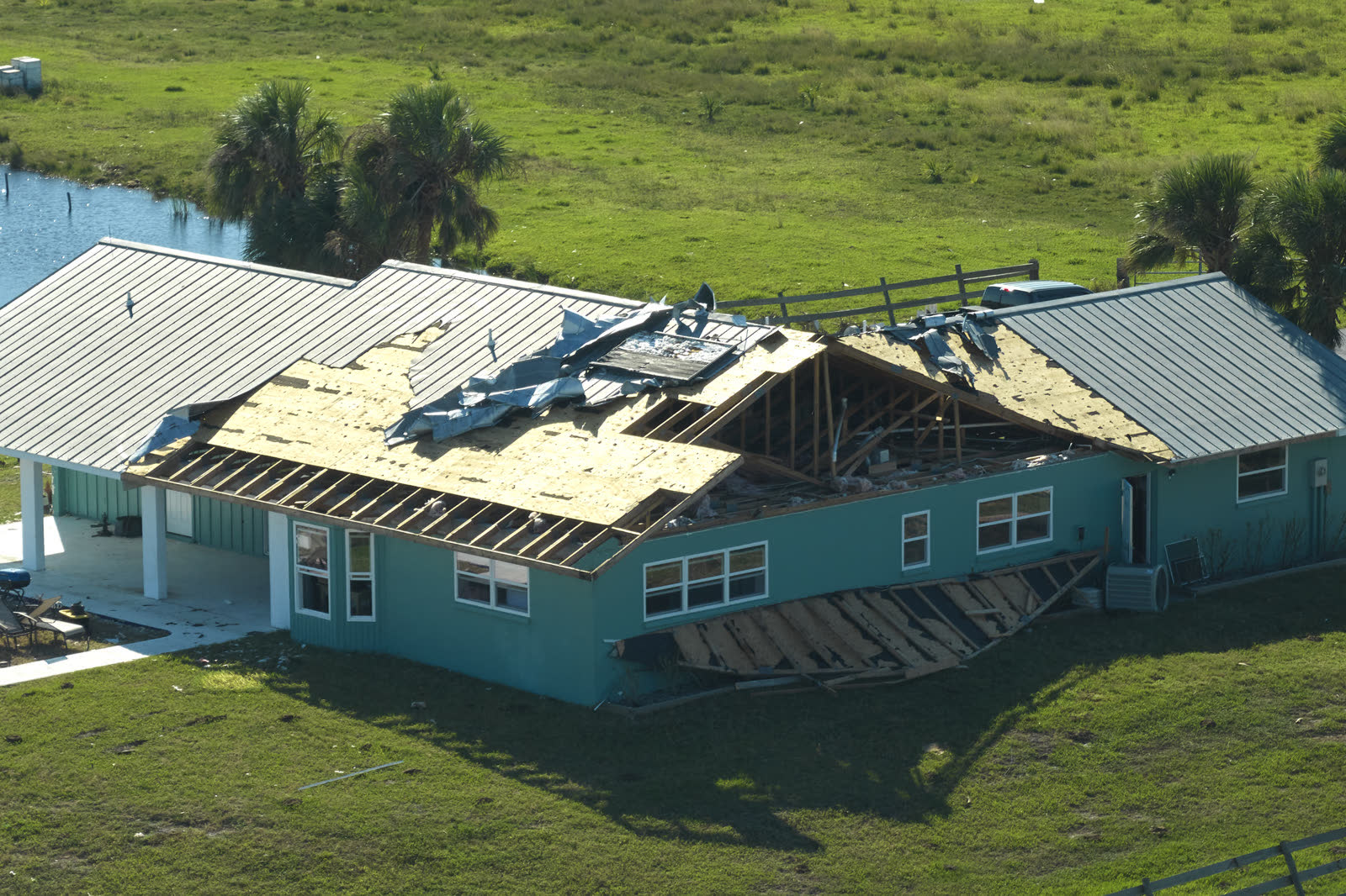 A house roof stripped of shingles by hurricane-force wind, the damage behind a denied Charleston, SC wind damage insurance claim