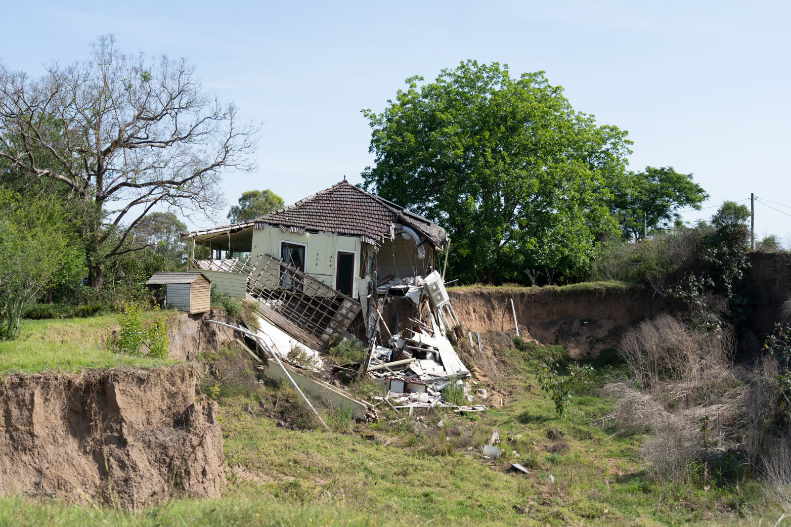 A house structurally collapsed after the ground beneath it gave way