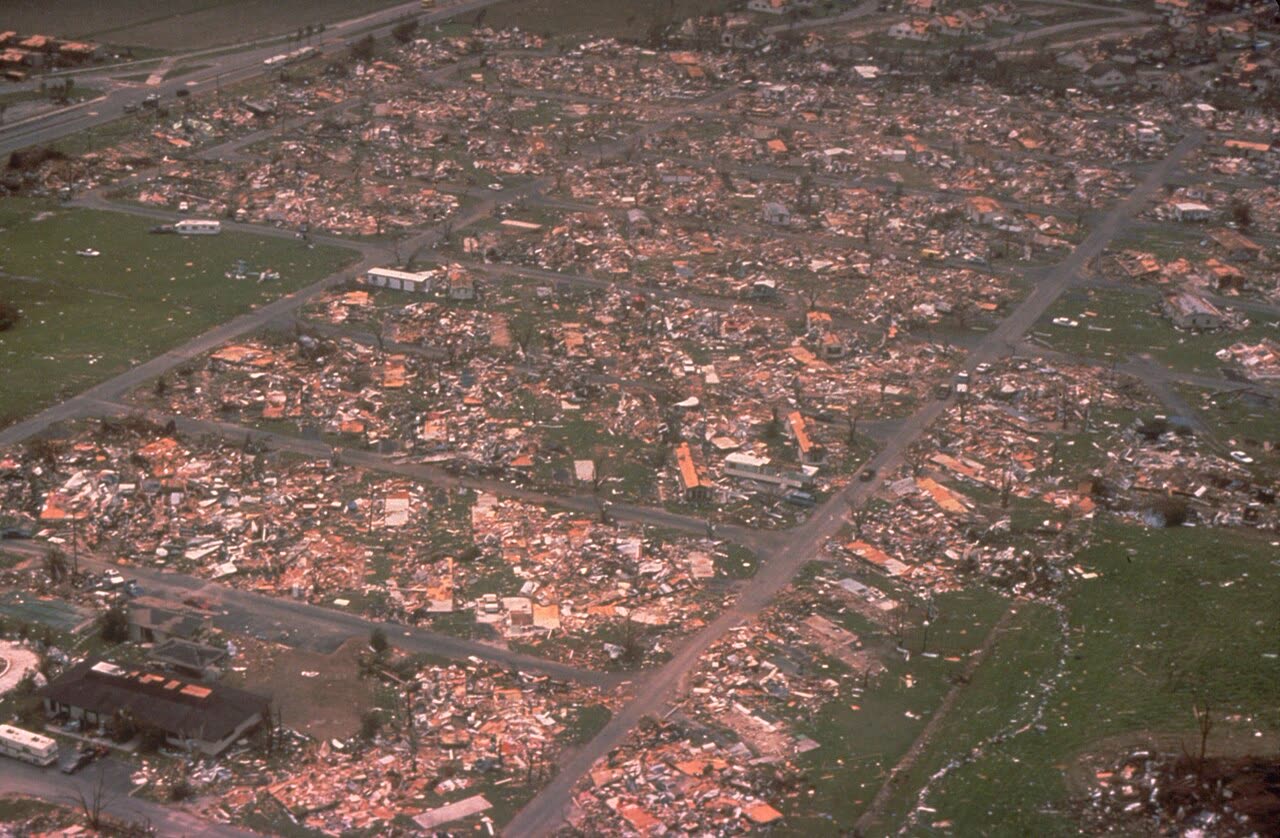 Aerial of flattened homes in southern Dade County — roughly 25,500 houses destroyed, 101,000+ damaged