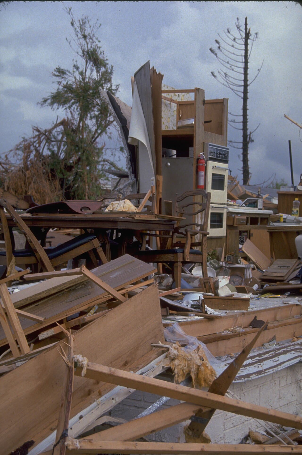 Wind-destroyed homes in the Homestead area — stapled roof sheathing failed first, then wind-driven rain gutted interiors