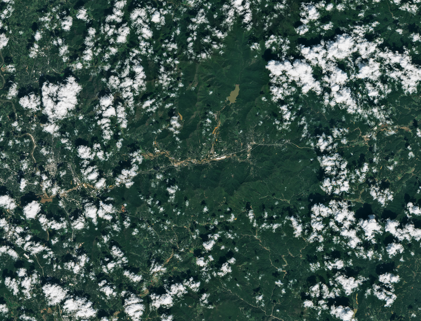Satellite view of flood-scoured river corridors across western North Carolina, October 2, 2024